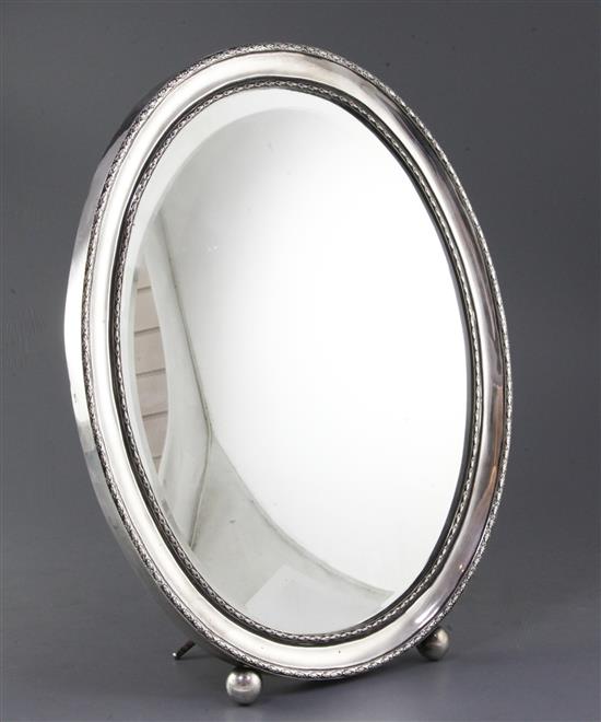 An early 20th century Portuguese 833 standard silver mounted oval easel mirror, 46cm